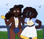 A drawing of Bauer Zimmerman and Tamara Crankit. Bauer is on the left, they are a Black man with medium-dark brown skin, long dark brown curly hair in a ponytail, a thick mustache, and dark brown eyes. He is a cowboy wearing a grey hat, a brown leather jacket, chaps, yellow gloves, and his Blaseball uniform as a shirt. Tamara is on the right, she is a Black woman with dark brown skin and a dark brown afro. She is wearing sunglasses and her Blaseball uniform which is a dress with pinstripes and the word \"Hands\" on it like Bauer's shirt. Bauer and Tamara are both looking at the camera, he is waving with his arm around her, and she is posing. Behind them is a fence with a field, likely at their blaseball stadium, The Pocket.