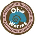 A digital drawing of a stylized blue nautilus shell on an uneven brown circle. There is a pink circle around the inside edge of the badge stylized to look like a worm. The words \"Ohio Worms\" are in the middle.